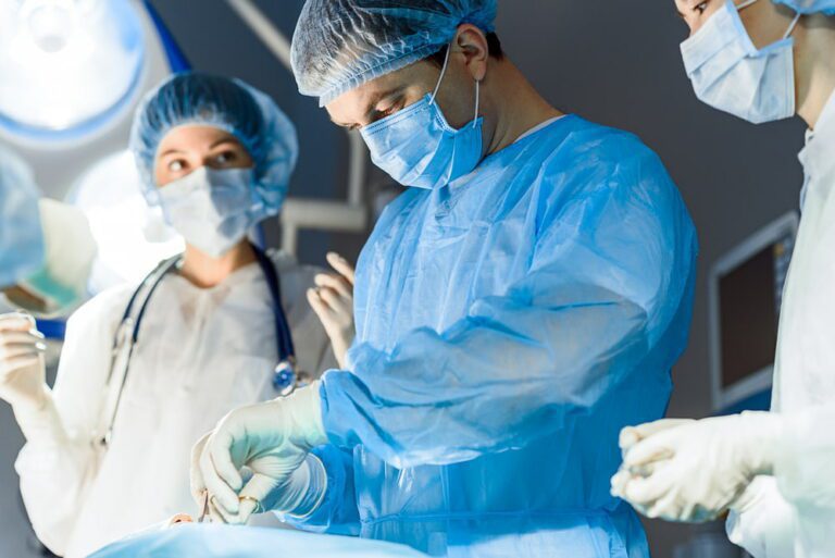 Médicos operando paciente em sala de cirurgia.
