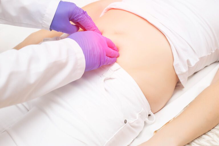 Médico examina paciente deitada na cama - como dormir após a cirurgia de hérnia inguinal