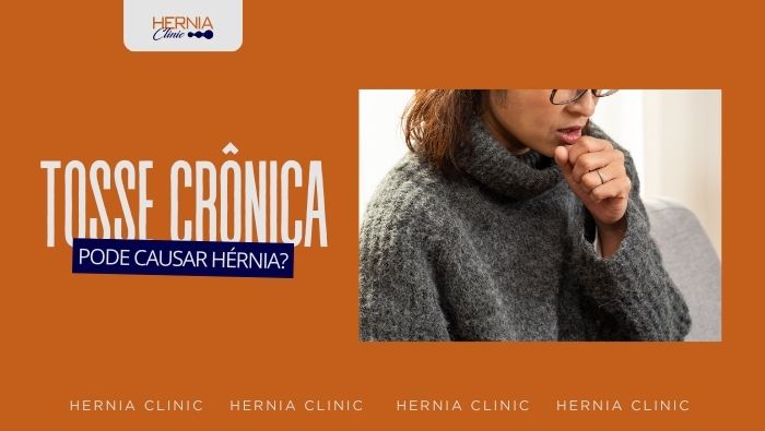 Pessoa usando suéter e óculos leva a mão à boca ao tossir, em ambiente interno, com expressão de desconforto respiratório.